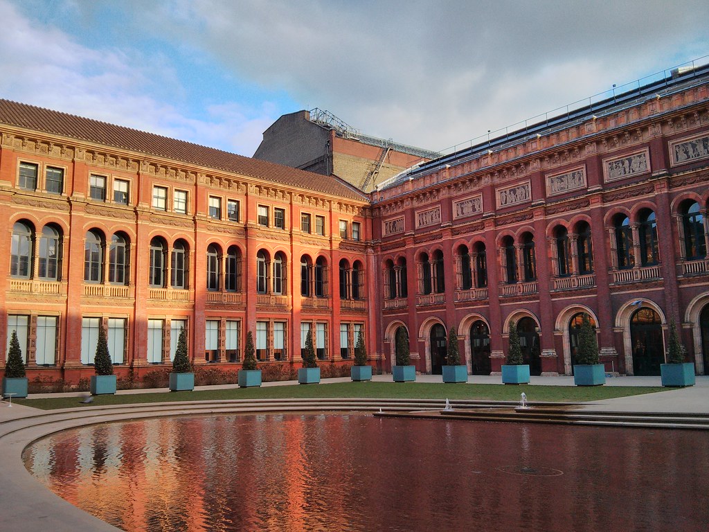 A wide shot of the exterior of the V&A museum and its paddling pool