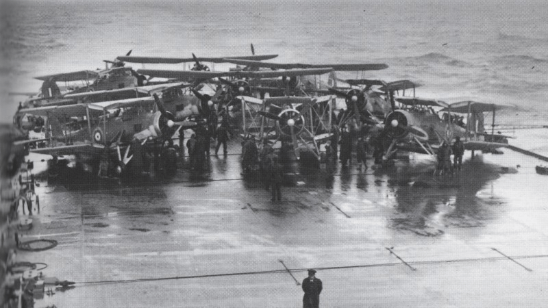Black-and-white photo of Fairey Swordfish biplane torpedo bombers on the after deck of HMS Victorious before the attack on the Bismarck.