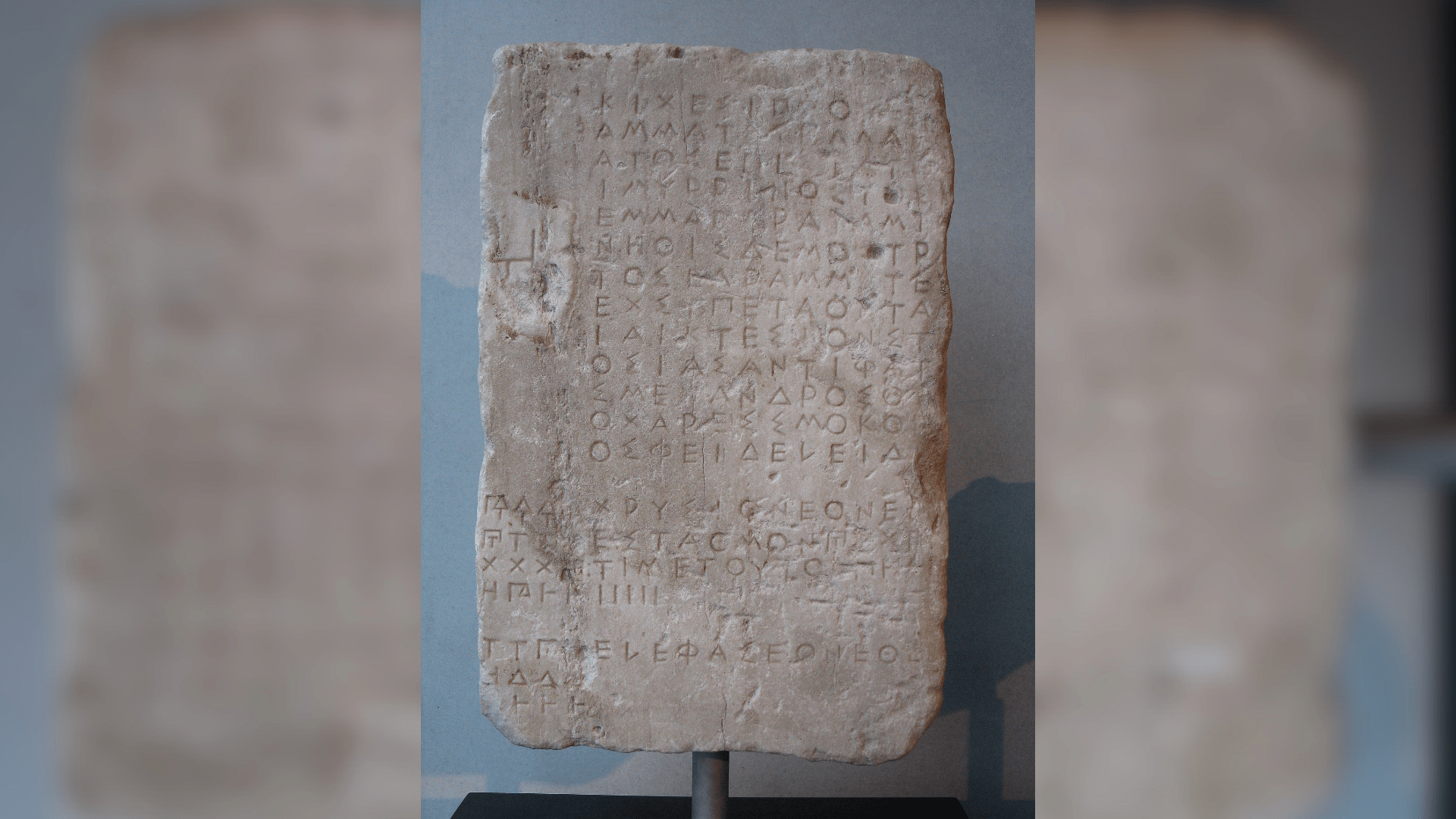 A stone tablet with Ancient Greek letters written on it.