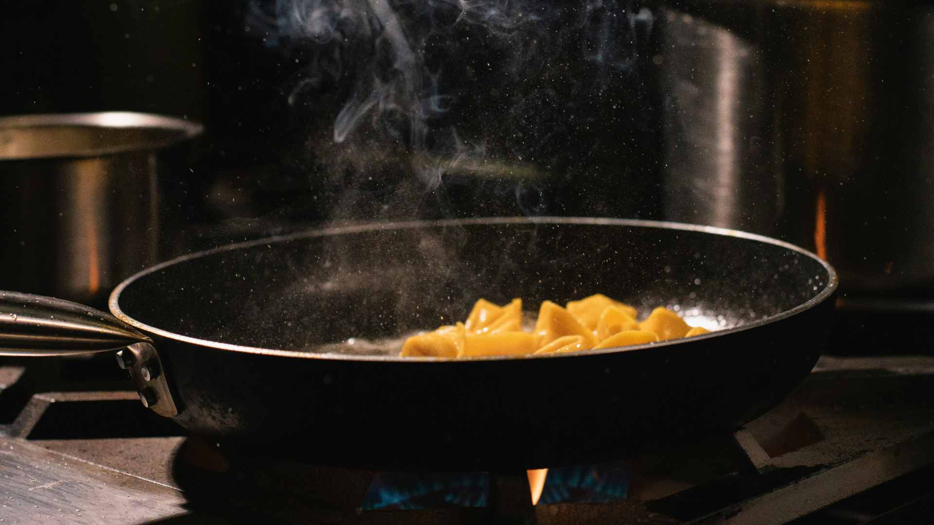 A pan releasing smoke as it cooks.