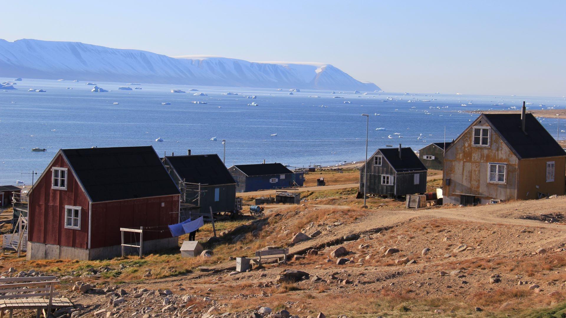 A cropped shot of several houses in Qaanaaq, Greenland.