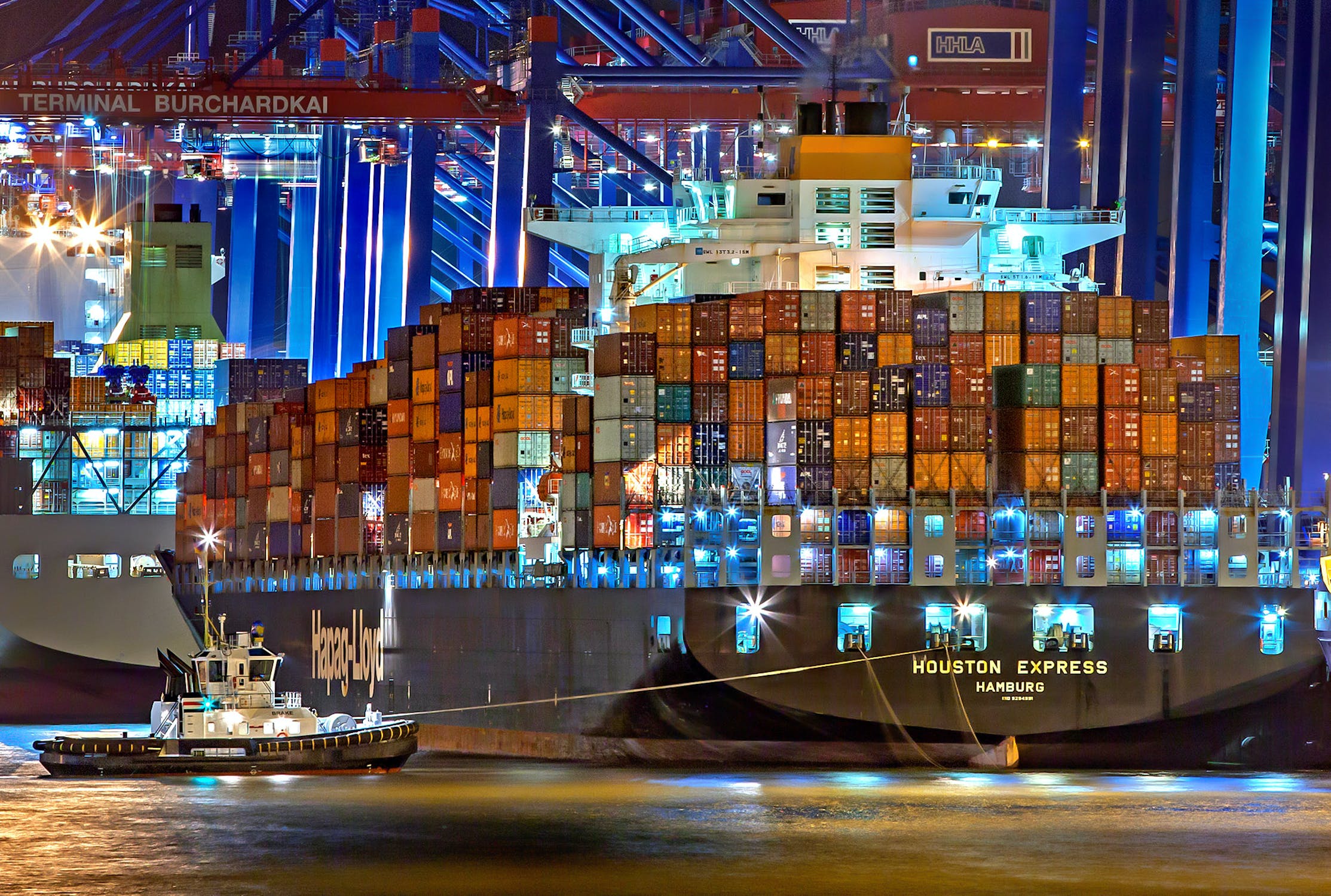 A cargo ship with shipping containers docked