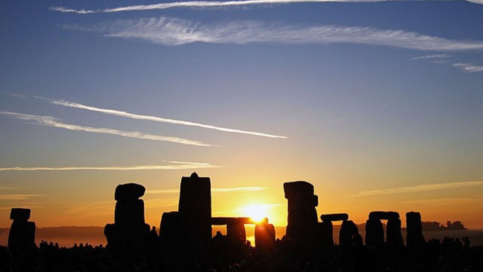 Stonehenge during Summer Solstice. The sun is rising over the stones.