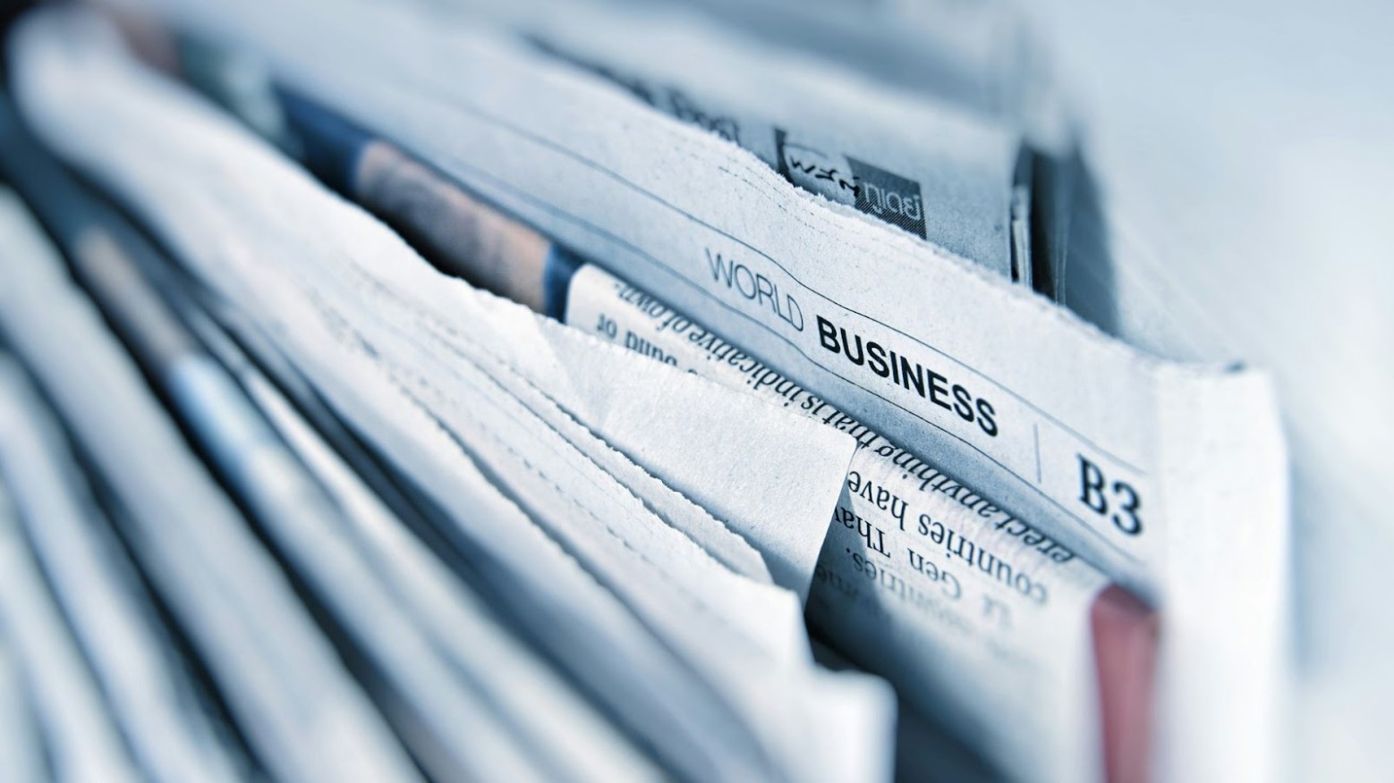 The edges of various newspapers stacked together