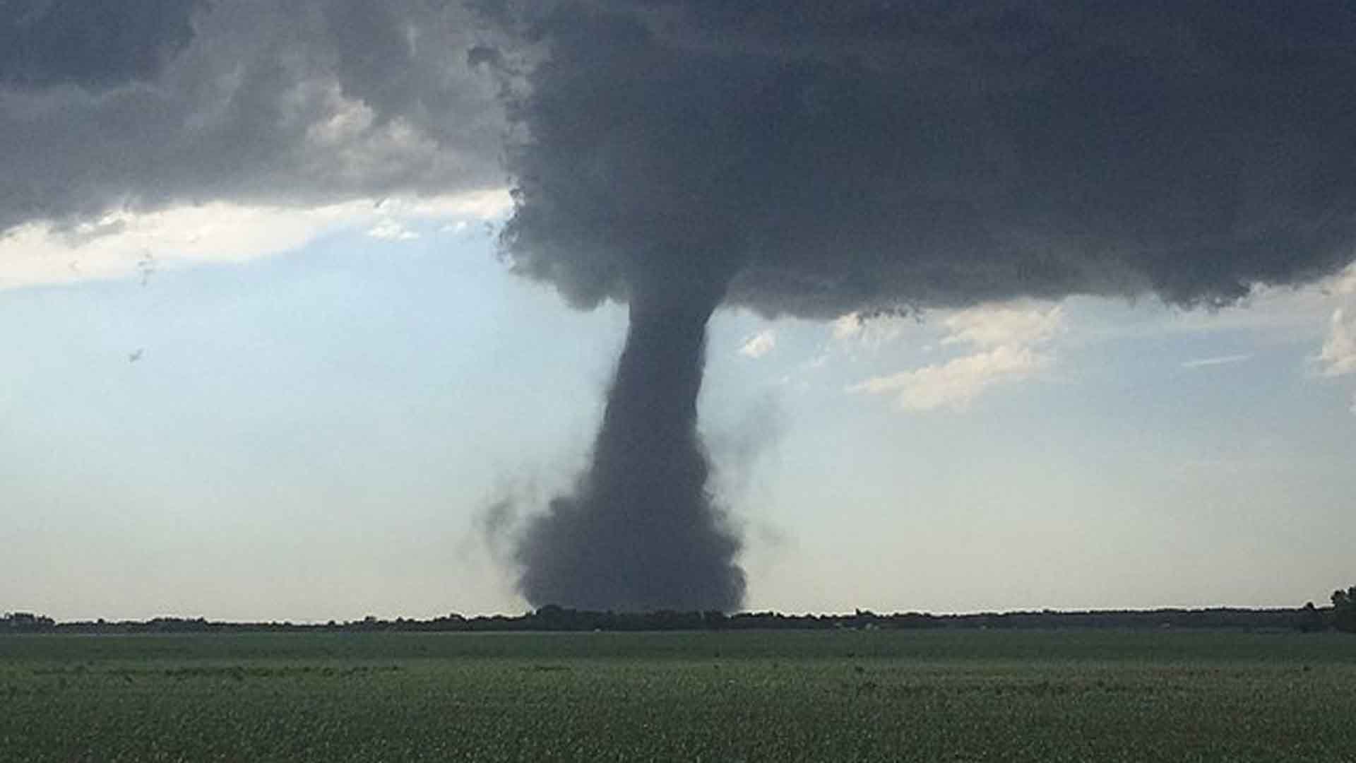 A dusty tornado tracking through fields in central Kansas