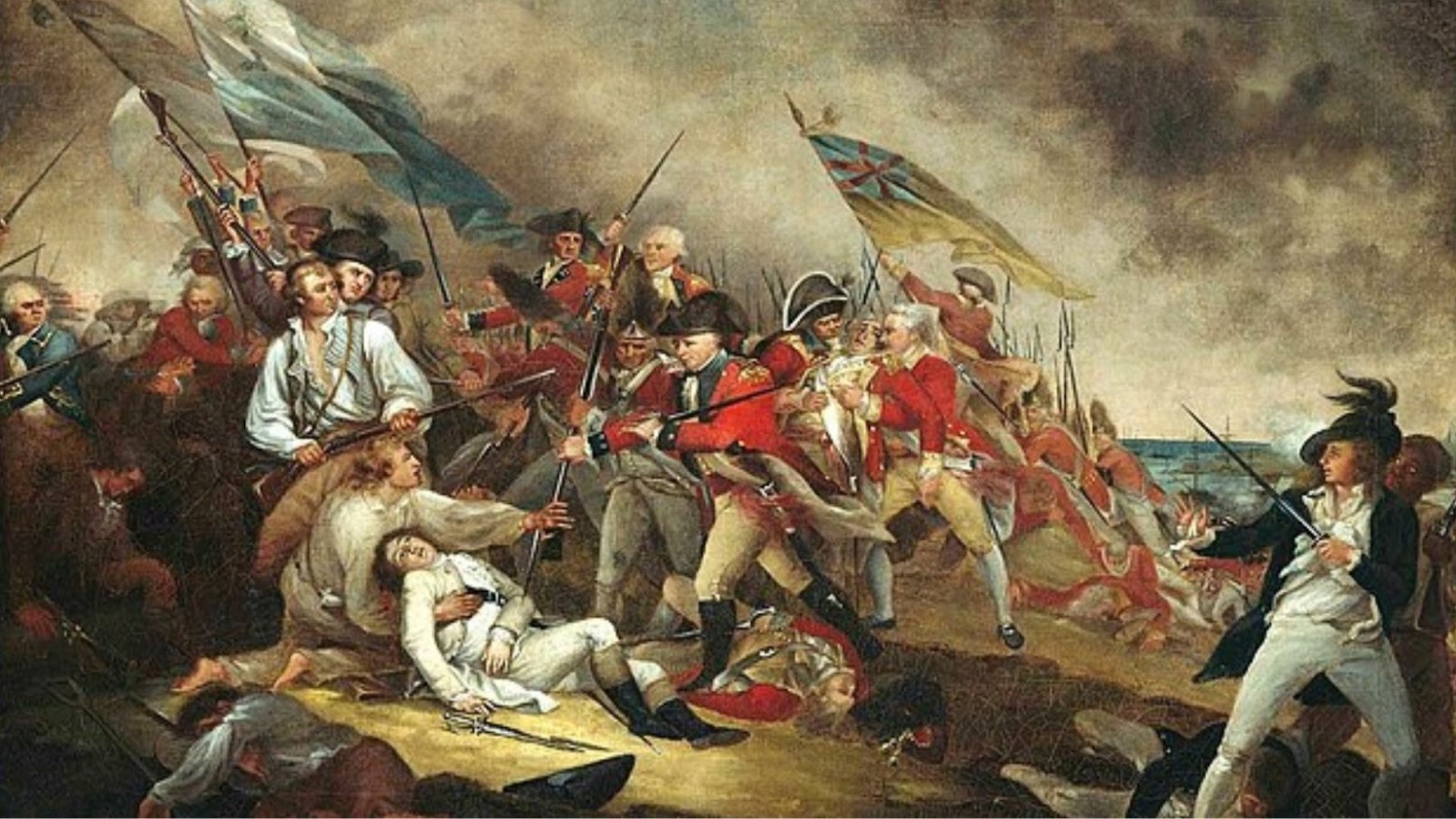 The Battle of Bunker’s Hill. One soldier is lying on the floor wounded, with another soldier holding him. Some soldiers are flying flags and others are pointing swords at others.