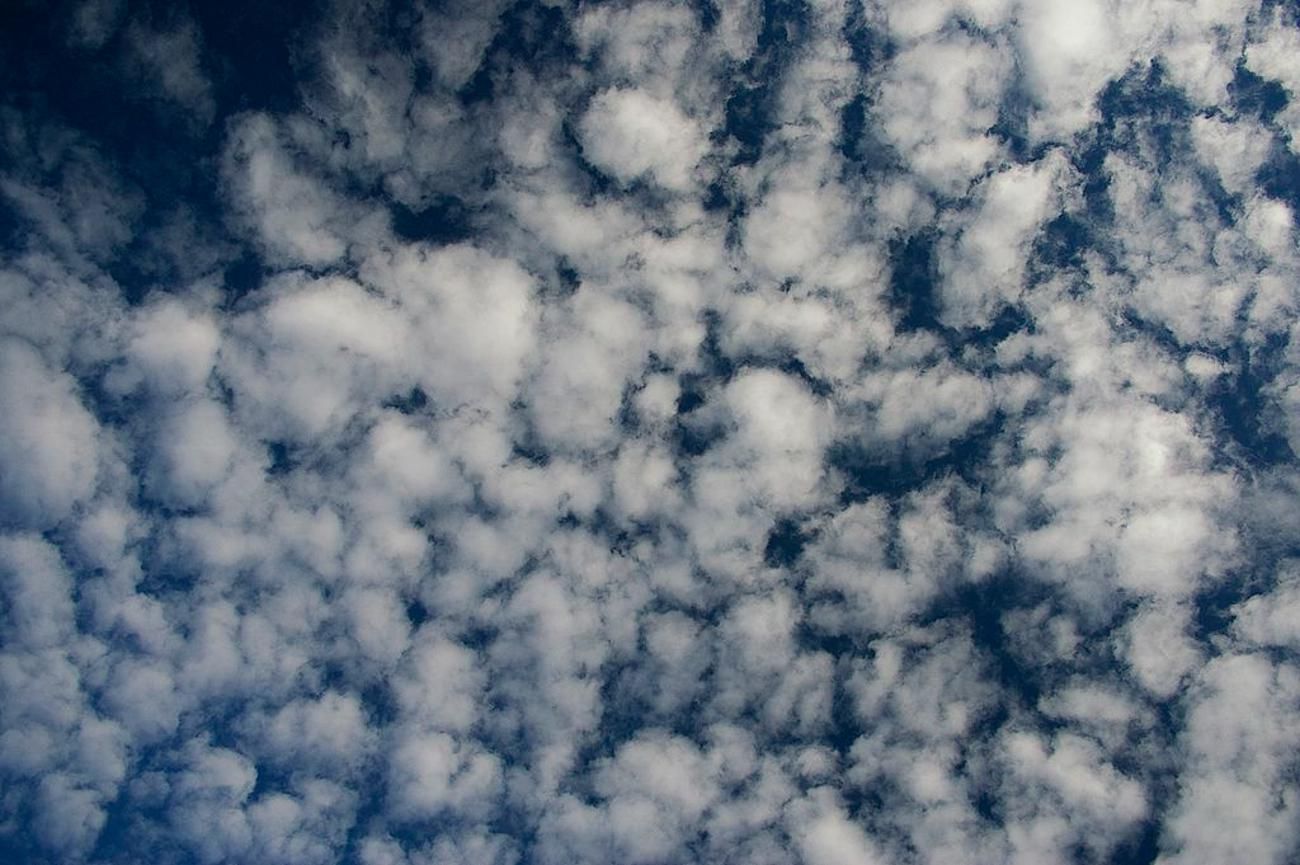Photograph of altocumulus clouds against a blue sky