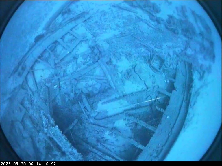 An underwater image of a sunken shipwreck