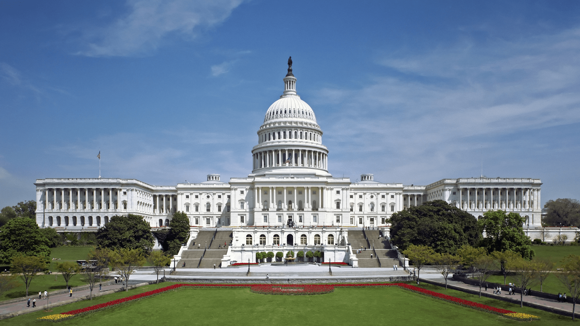 The western front of the United States Capitol photographed in day time.