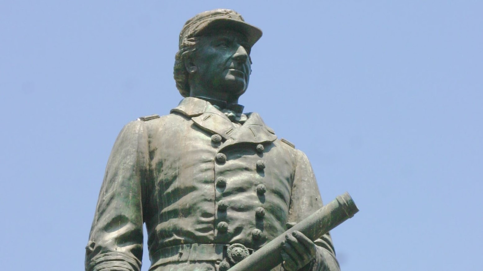 A statue of David Farragut seen underneath a clear blue sky.