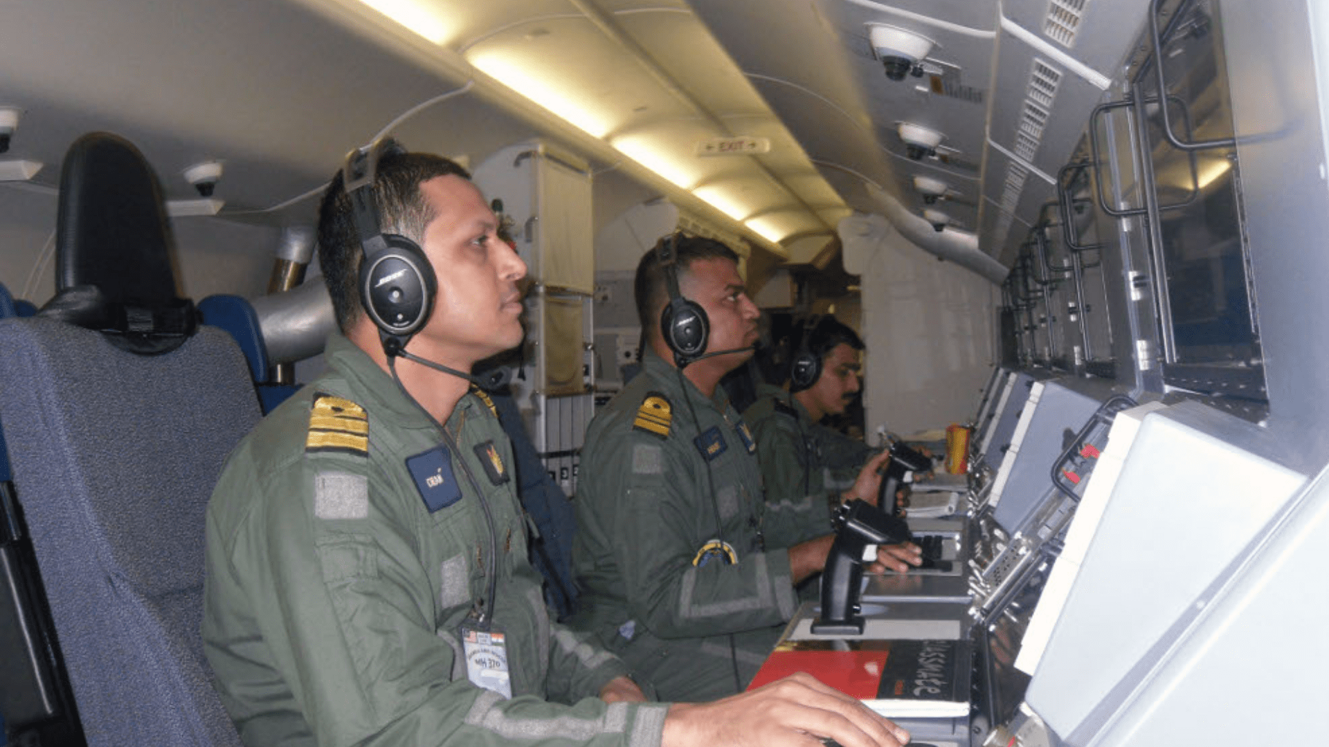 Indian Navy's Boeing P-8I crew at their work stations during a search and rescue sortie for Malaysia Airlines Flight 370 in South Indian Ocean on 23 March 2014.