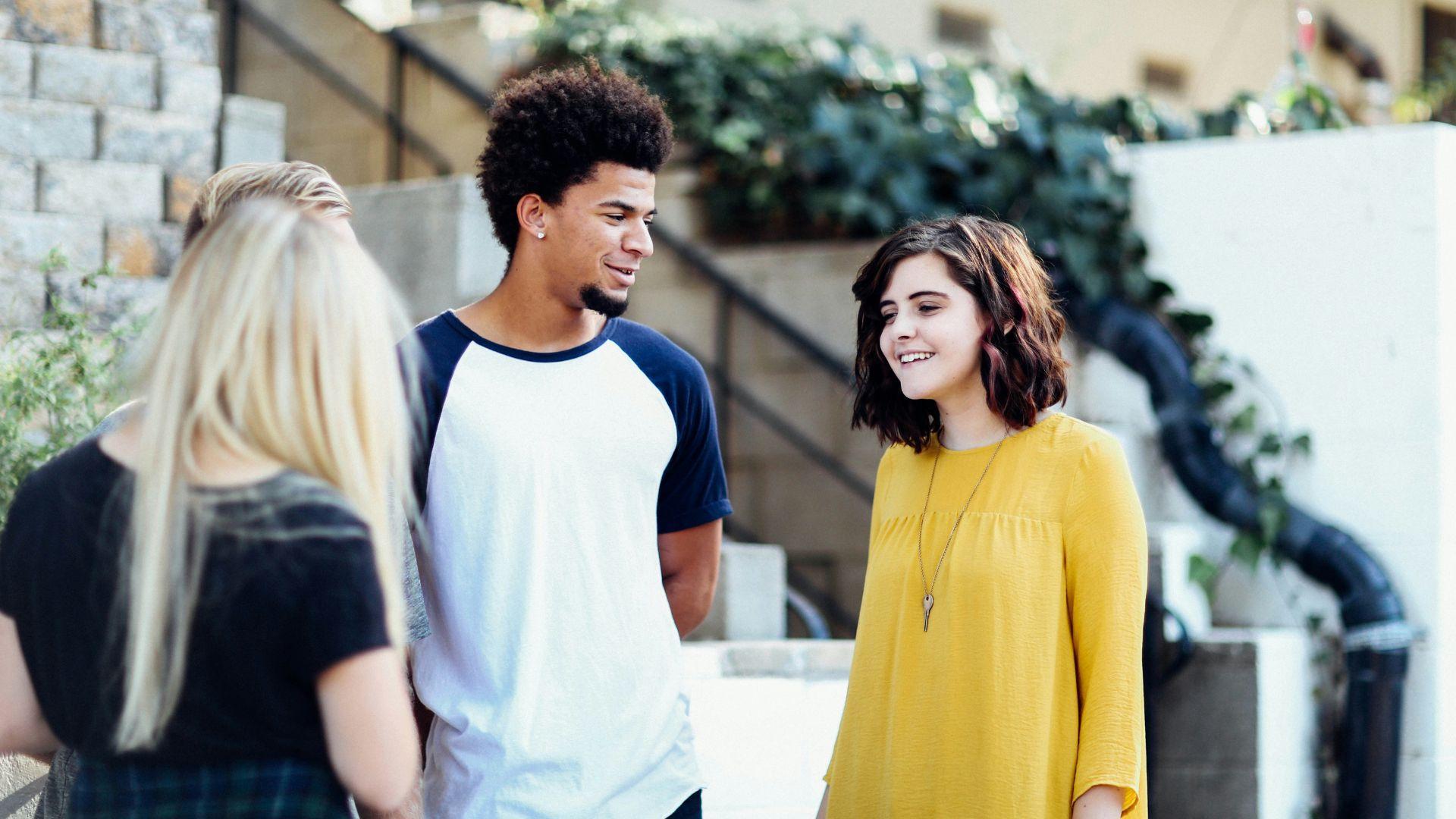 Young people talking together while outside.