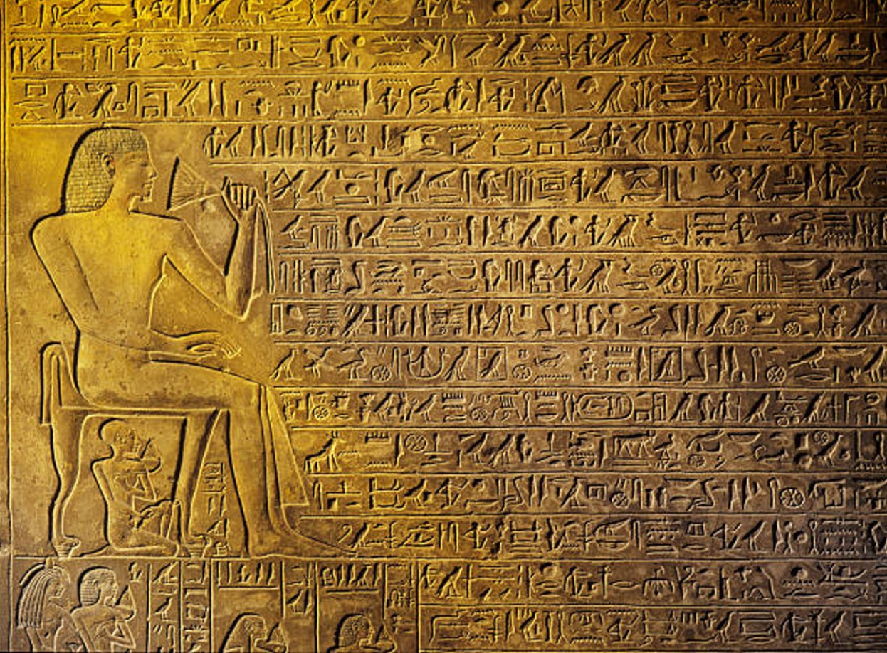 Depiction of an Ancient Egyptian scribe writing in hieroglyphs
