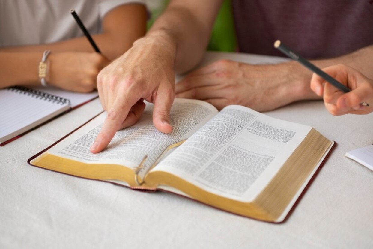 A group of people reading and discussing the Bible