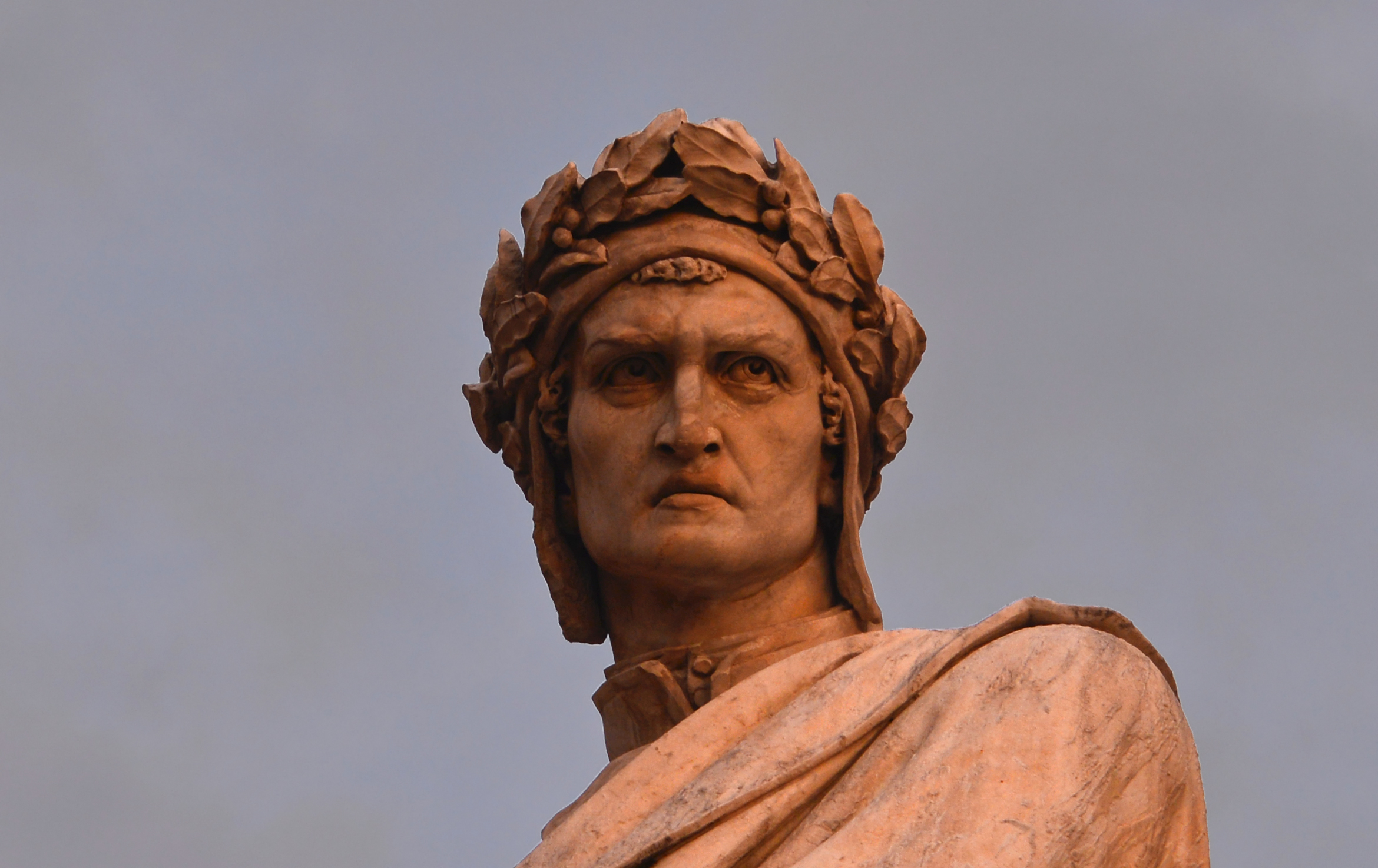 A statue of Dante Alighieri with a crown of branches