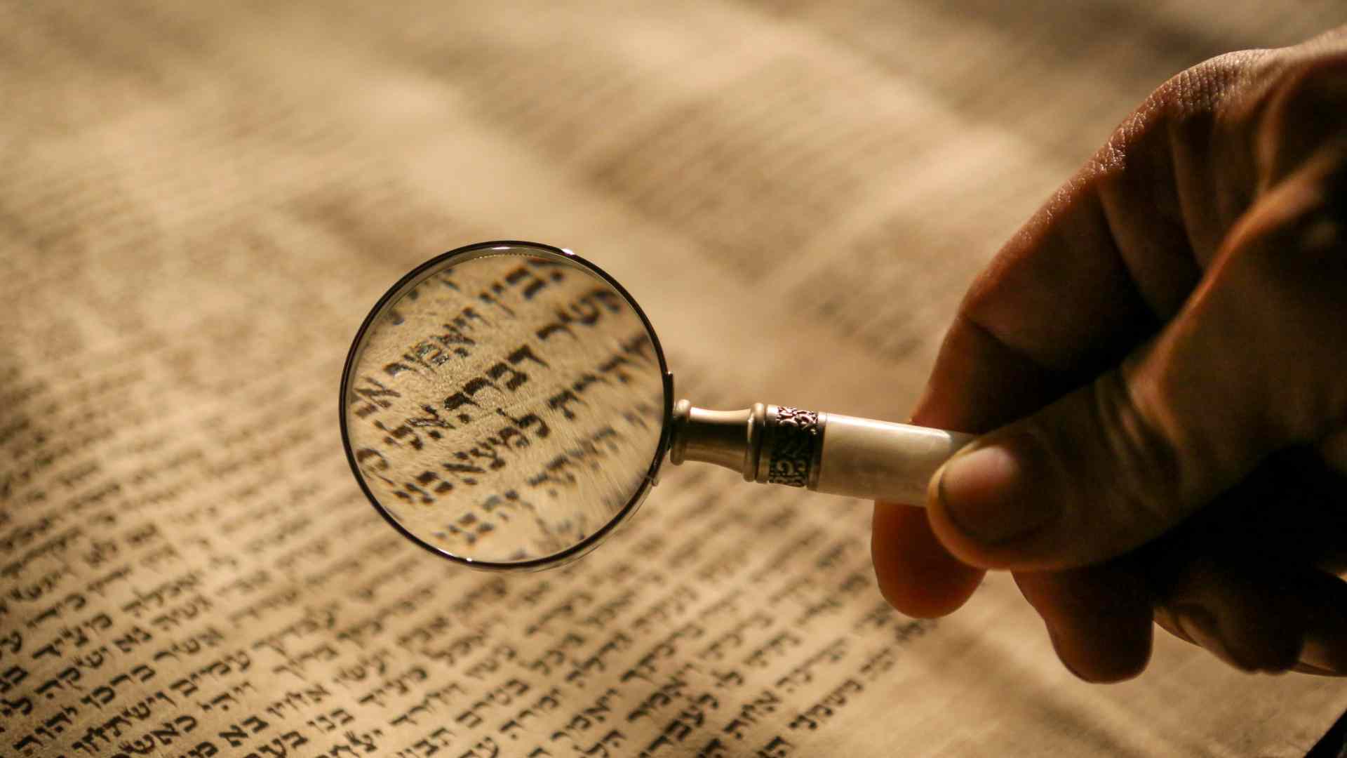A magnifying glass looking over text.