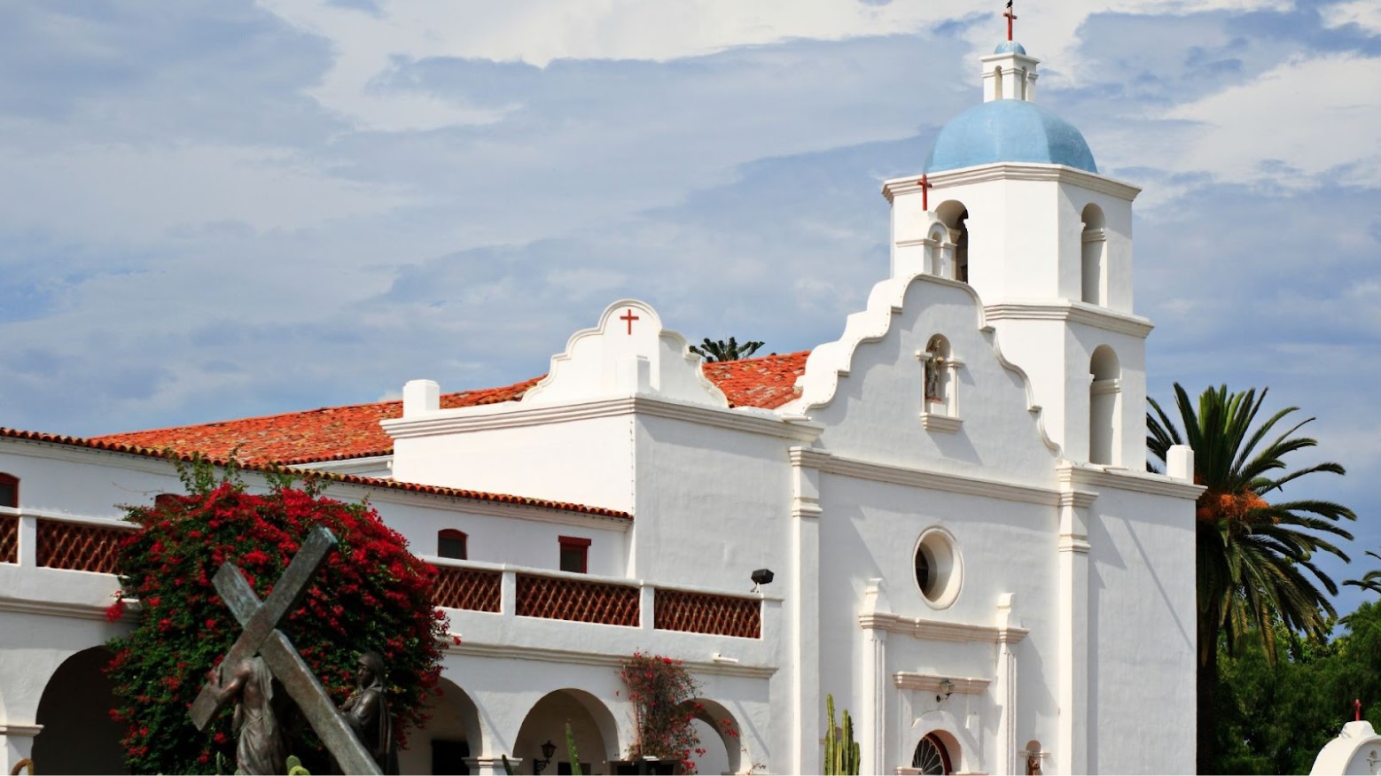 The outside of Spanish style missions building is shown against a blue sky