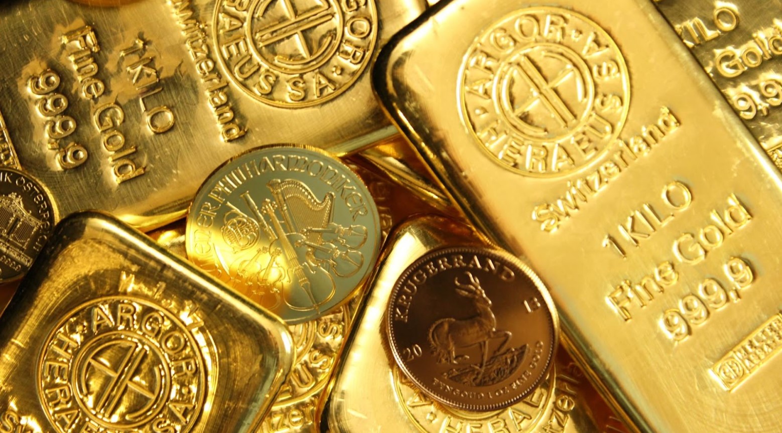 Bars of gold and gold coins all in a pile together.