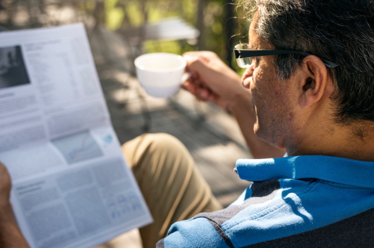 A man is pictured reading the newspaper