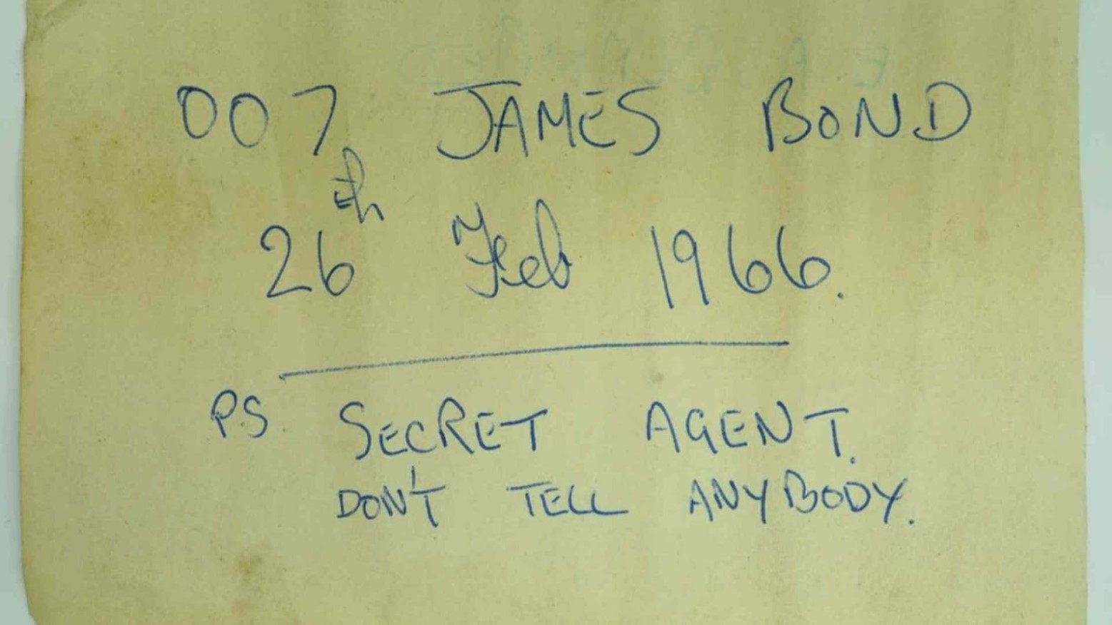 Yellowing paper with “007 James Bond 26th Feb 1966 P.S. Secret agent don’t tell anybody” written on it.