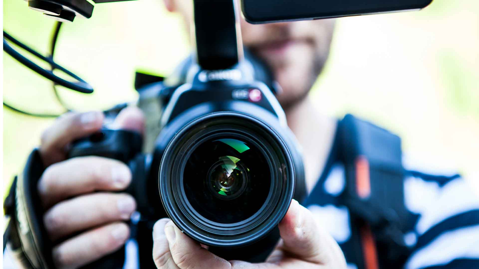 Person Holding Canon Dslr Camera Close-up Photo