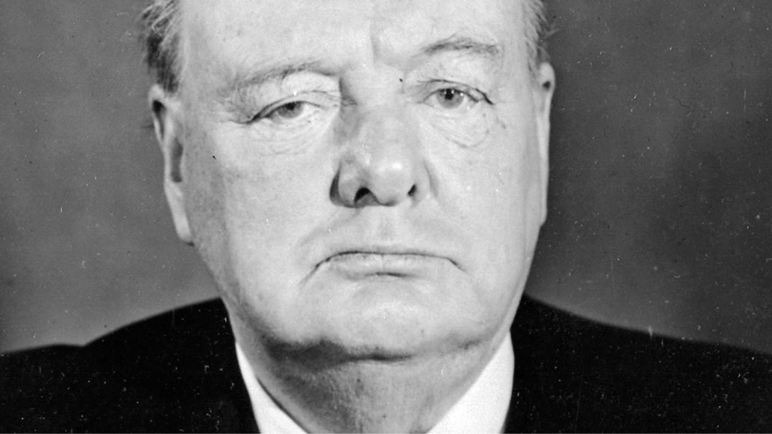 A black and white portrait photo of Winston Churchill.