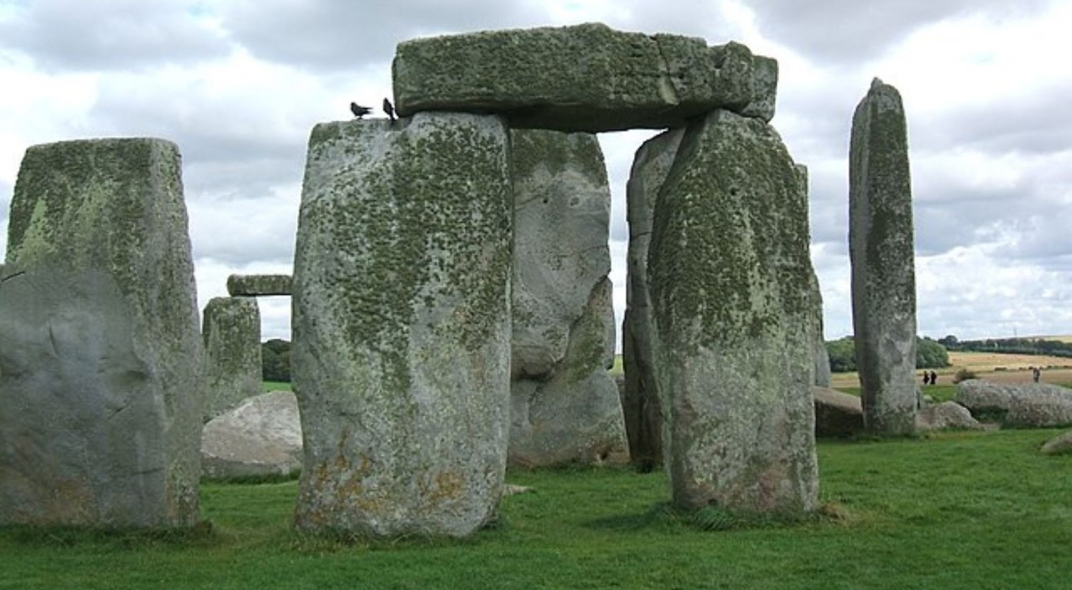 A close-up of Stonehenge. Some of the stones have moss on them at the top.
