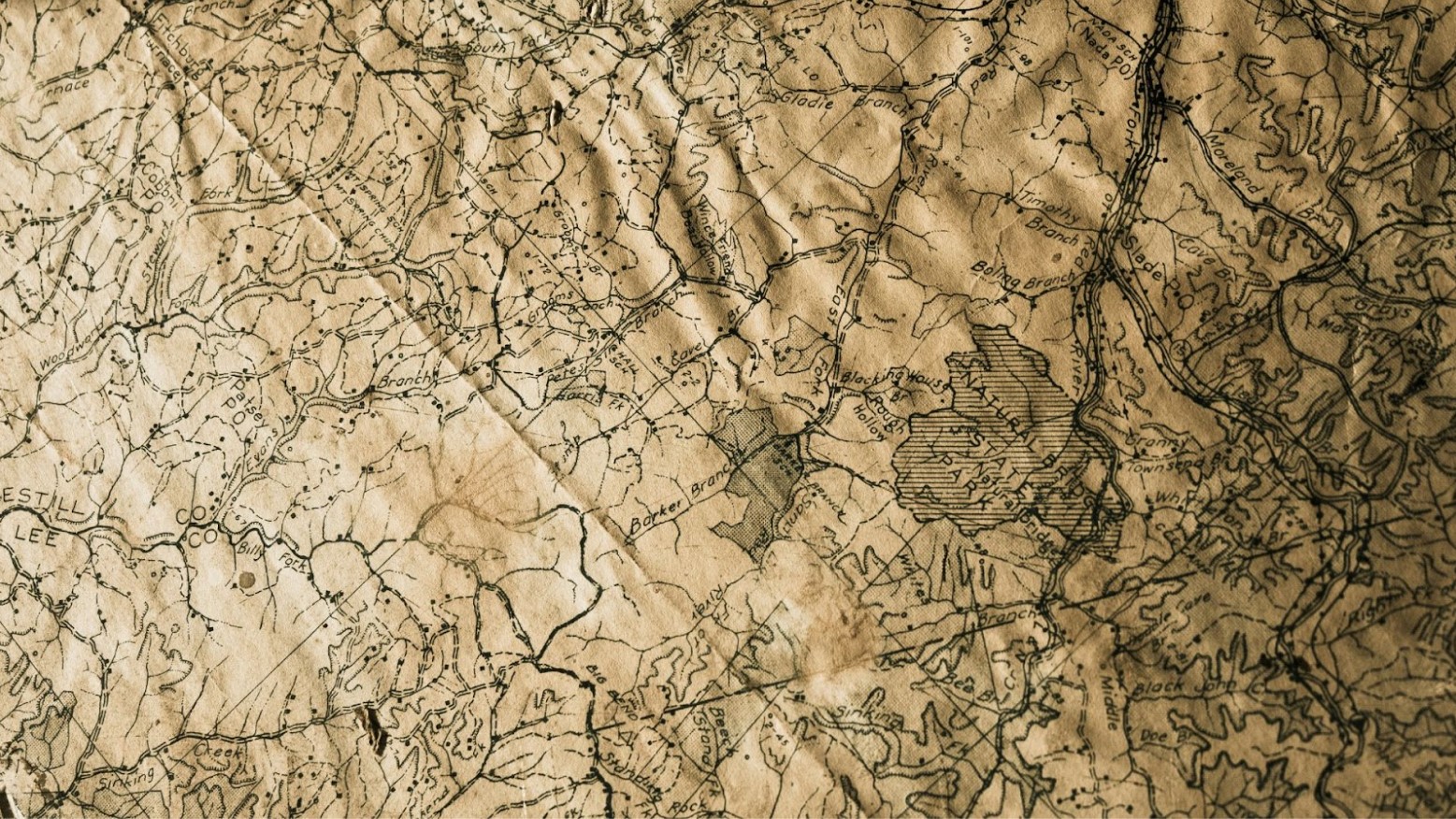 An old brown map that is wrinkled.