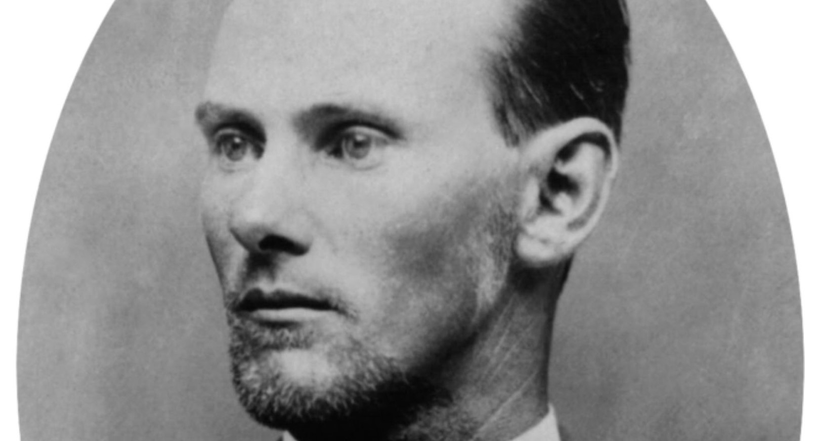 A black and white photo of Jesse James with his head slightly turned to the side.