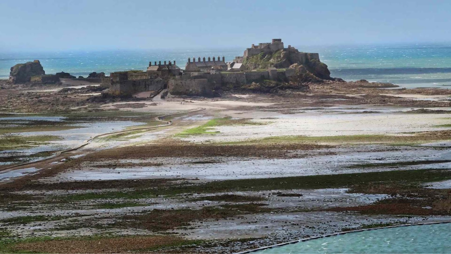 Elizabeth Castle is in the distance, with a dry causeway leading to it