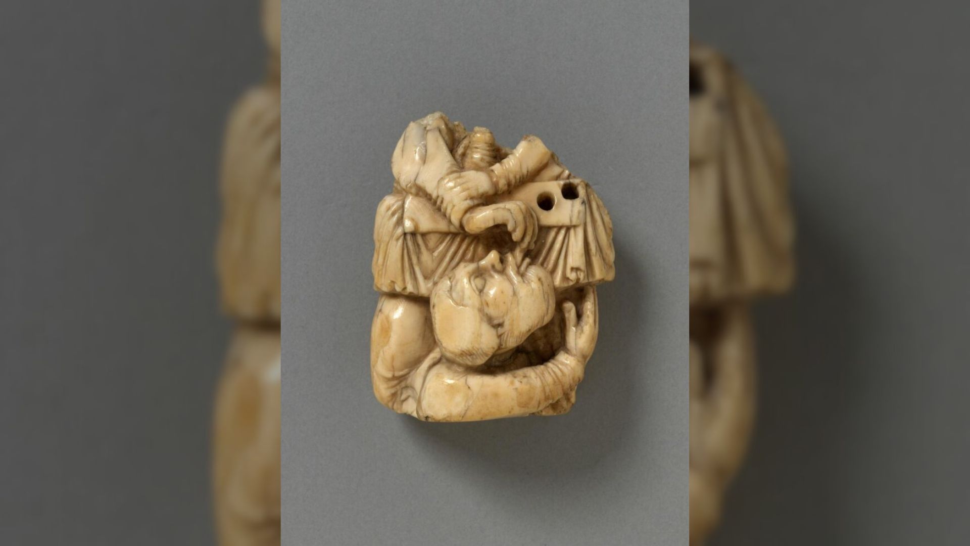 An aged ivory sculpture of Judas at the Last Supper