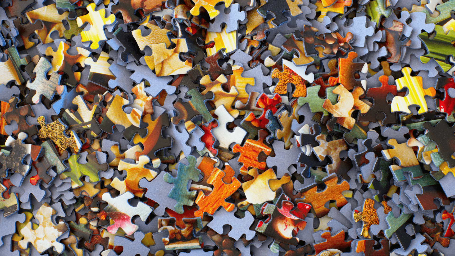 A pile of jumbled puzzle pieces.