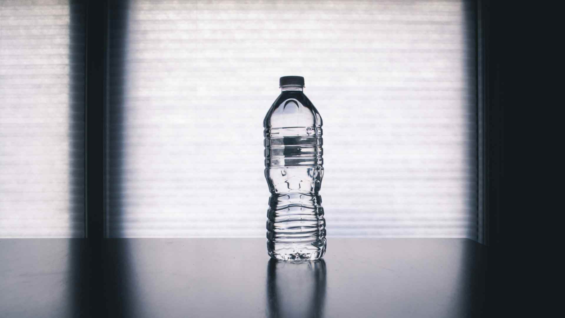 A bottle of water sitting on a table.