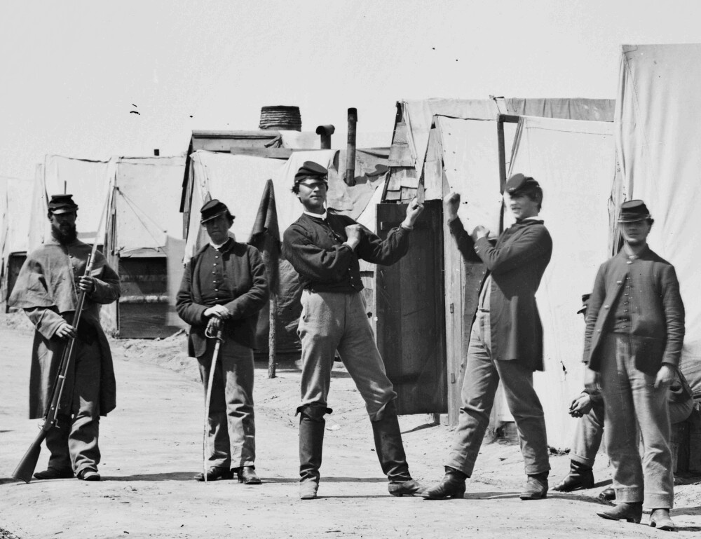A grayscale photograph of Union Soldiers boxing