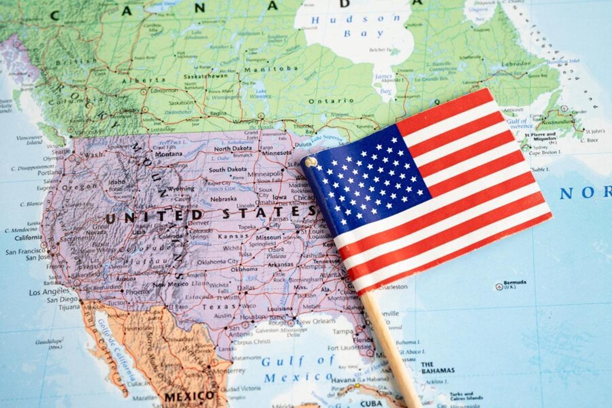 Map of the USA with a mini American flag on top