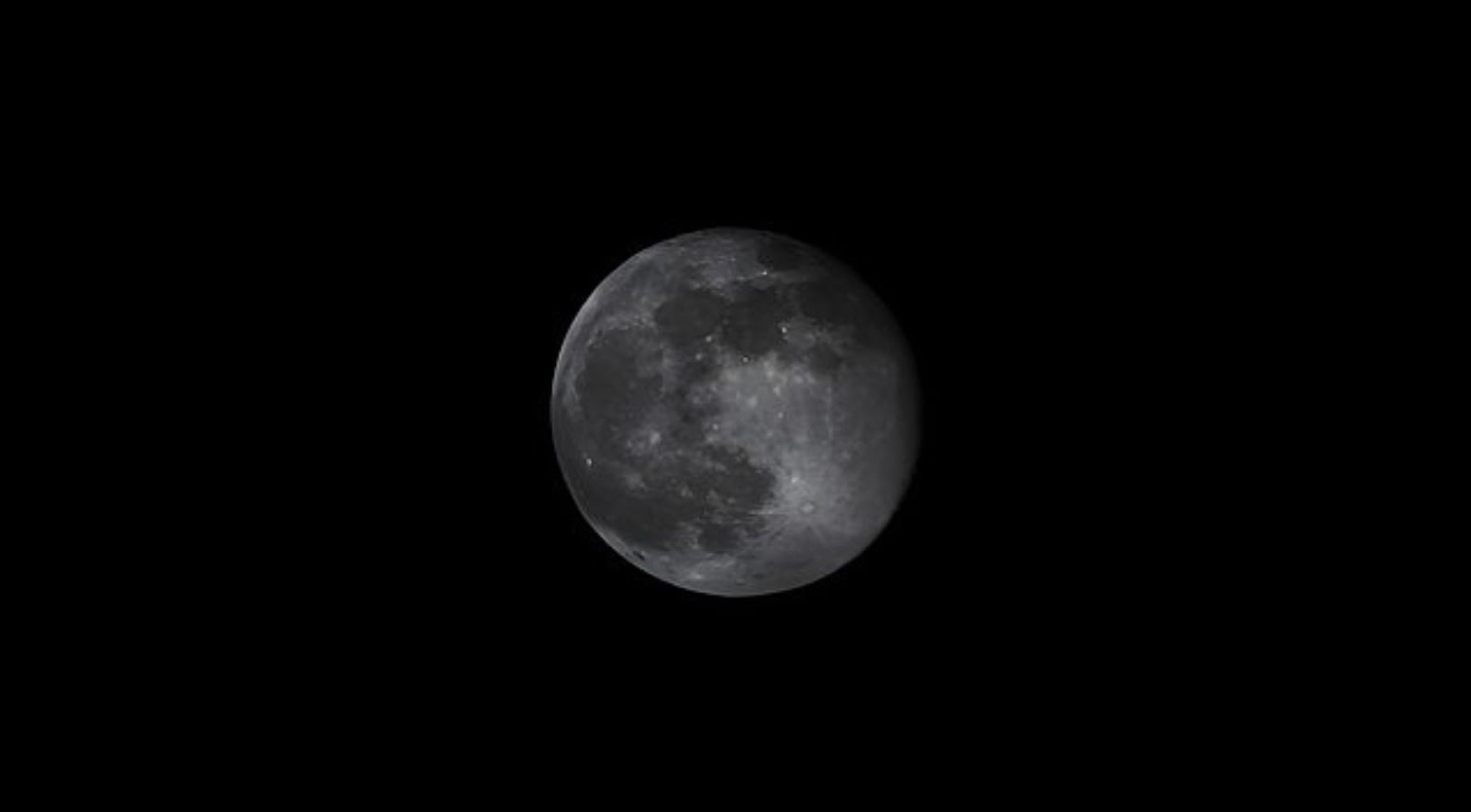 The full moon in a black sky.