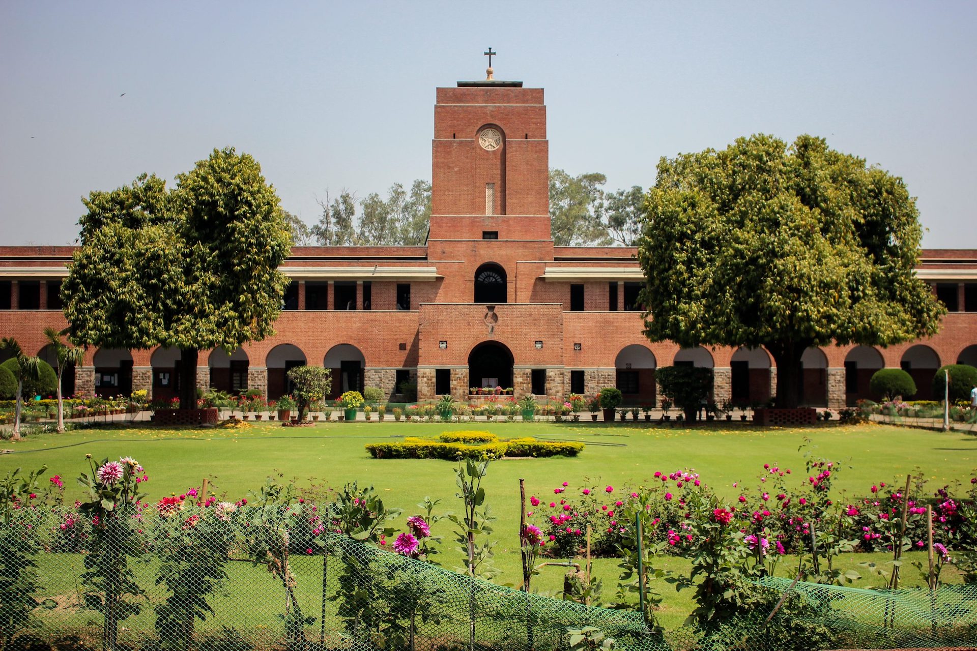 A wide shot of a brick building and a large open yard at the College of Saint Stephens