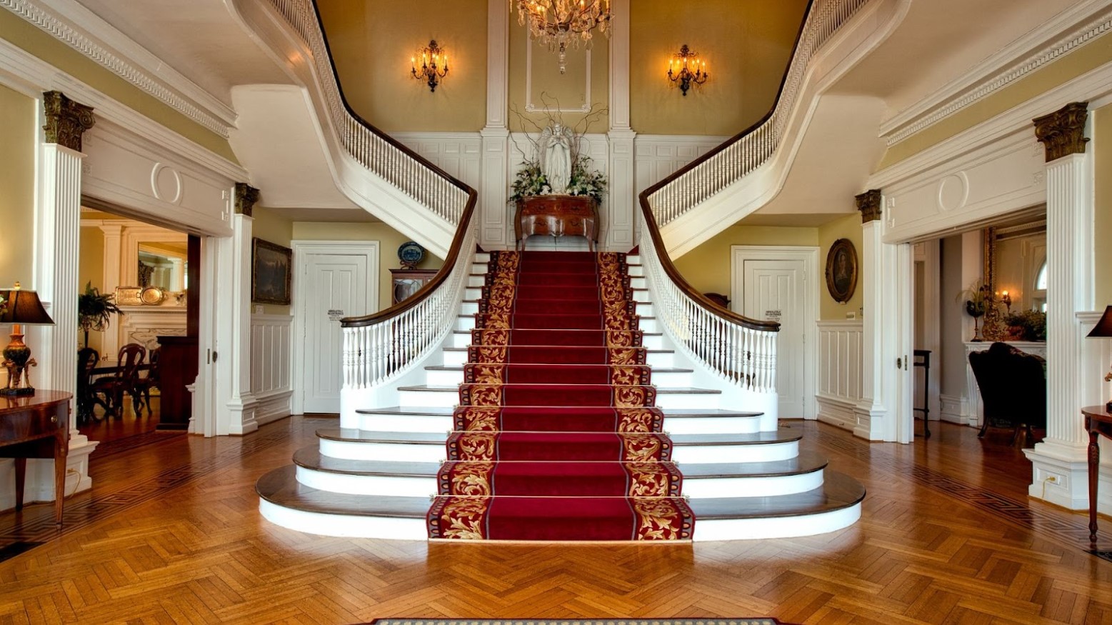 A large double staircase inside of a mansion