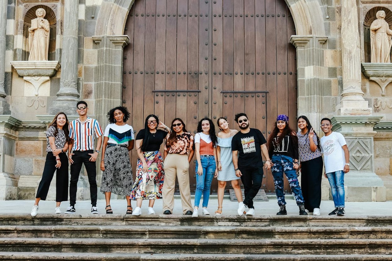A group of youths standing in front of a church door