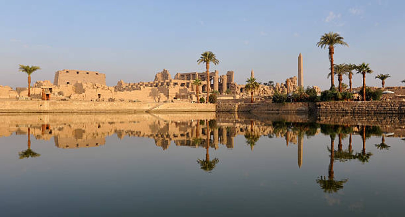 Photograph of the ruins of Ancient Egypt reflected in the Nile River