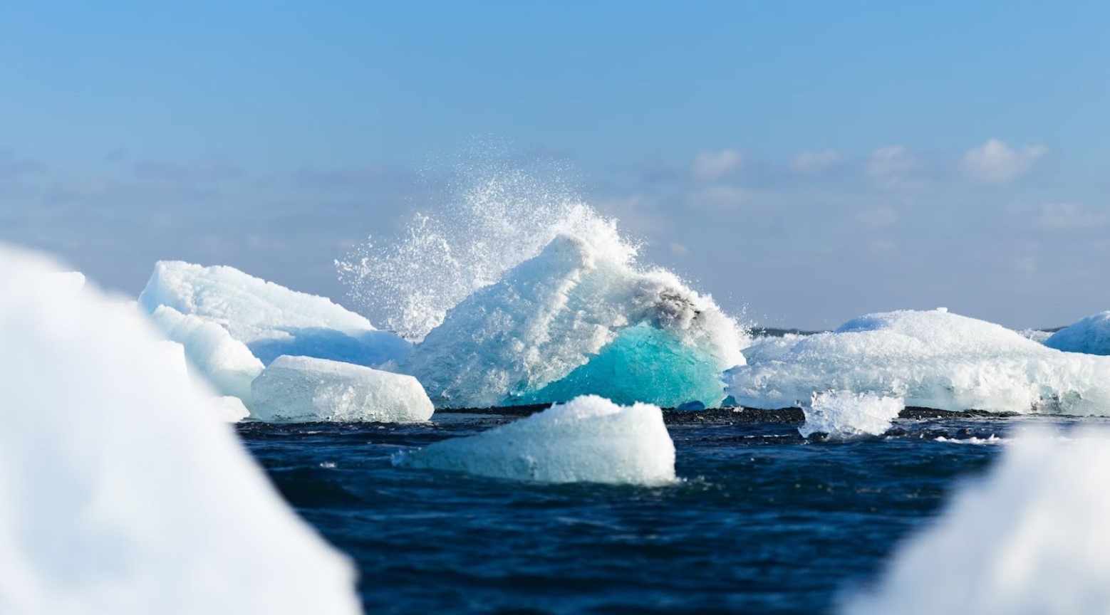 Ice caps melting in the sea. The ice has a lot of gaps between them.