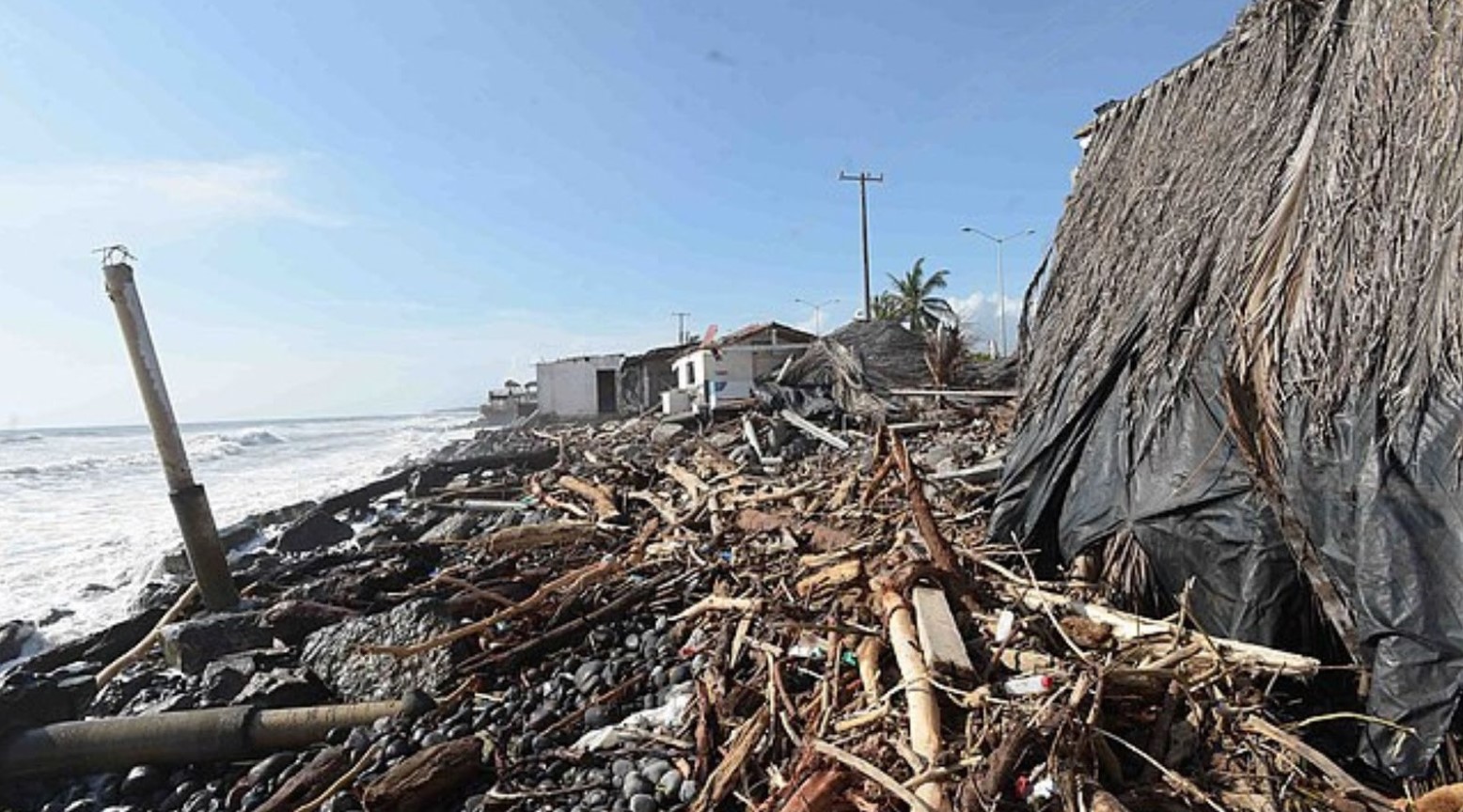 An image of the damage from Hurricane Patricia. The damage is by the sea and the beach is covered in debris.