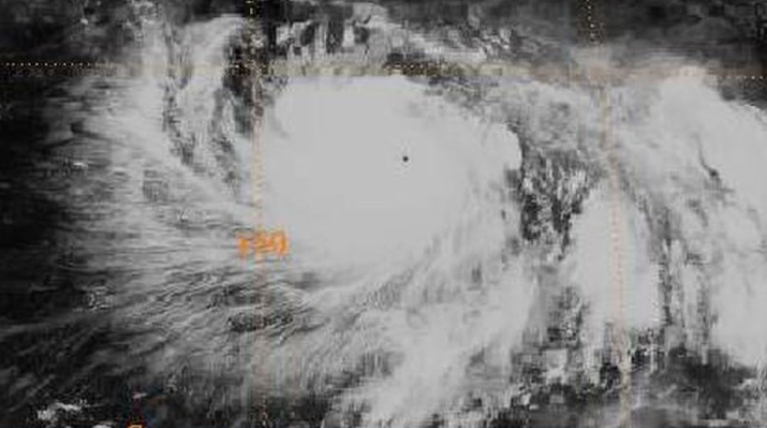 A satellite image from Typhoon Gay. The satellite shows a white cloud circling, with orange lines from the satellite on top.