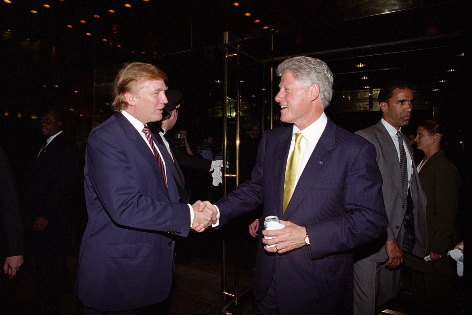 An image of Bill Clinton shaking hands with future US president Donald Trump in 2000