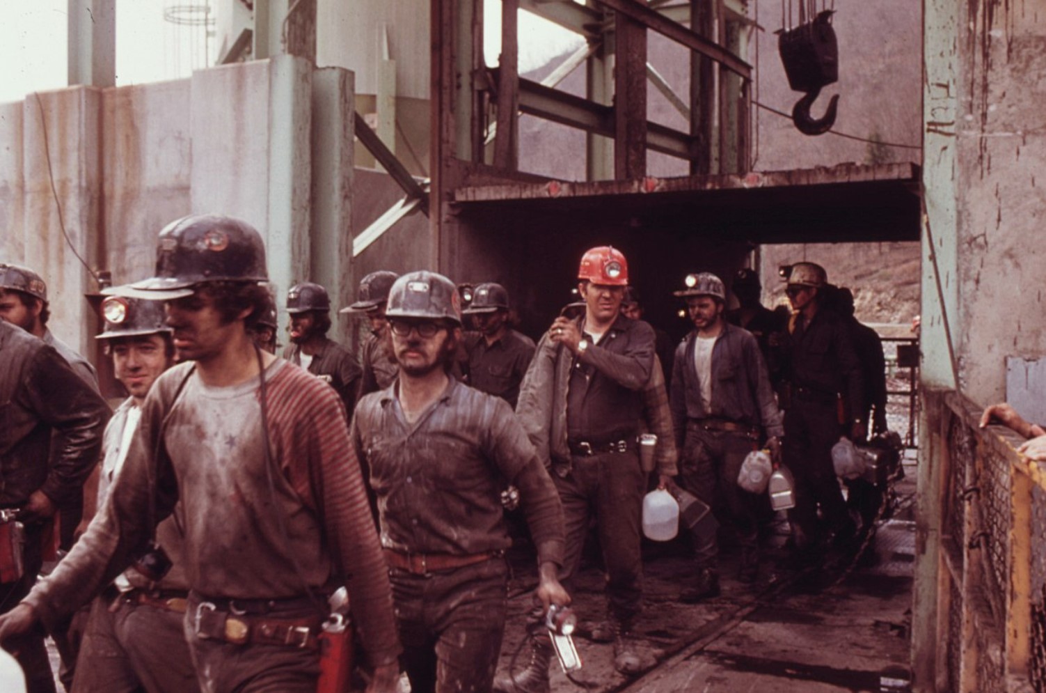An image of several miners leaving their workplace after a long day