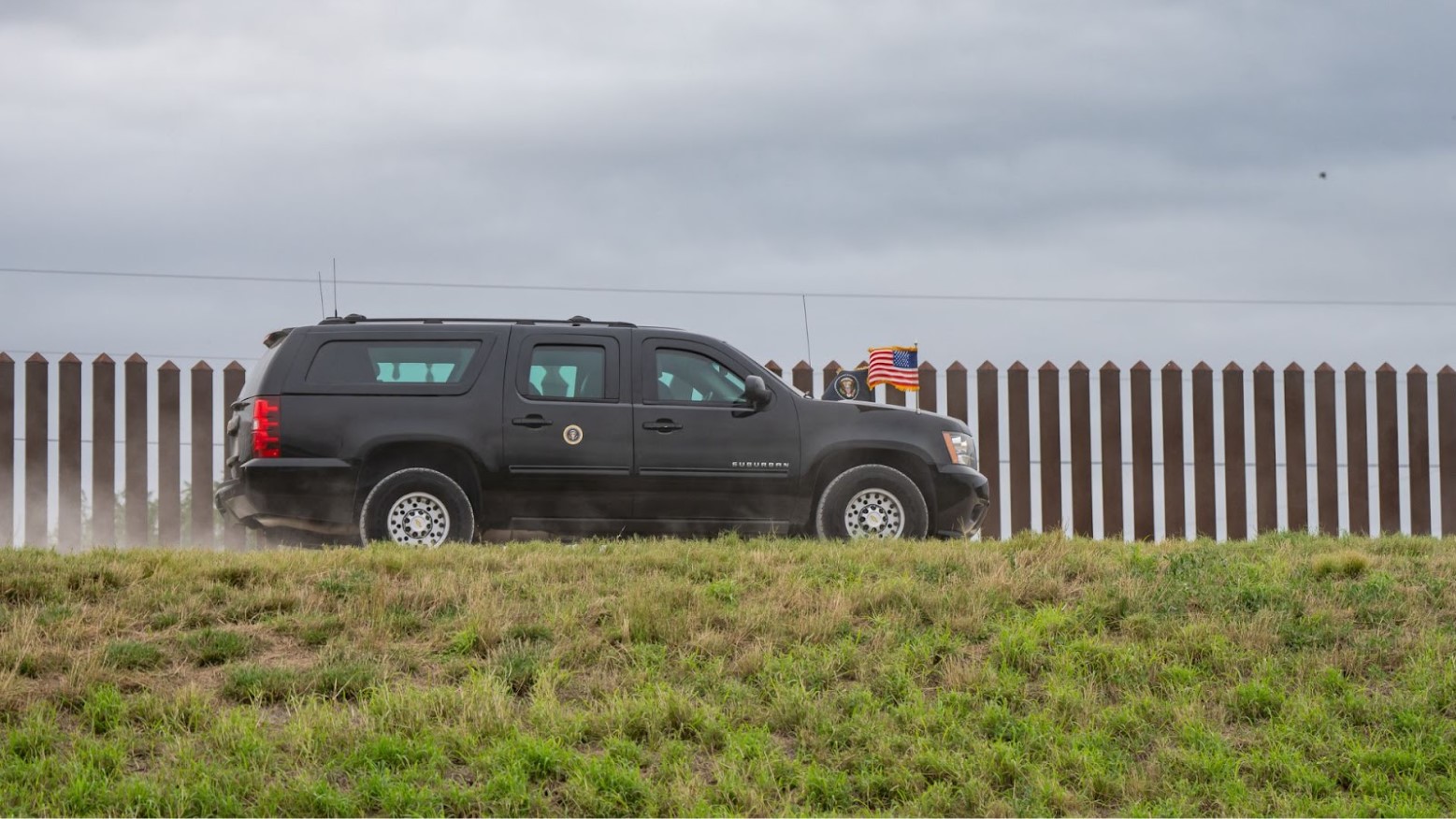 President Joe Biden’s motorcade drives alongside the Texas-Mexico border wall.