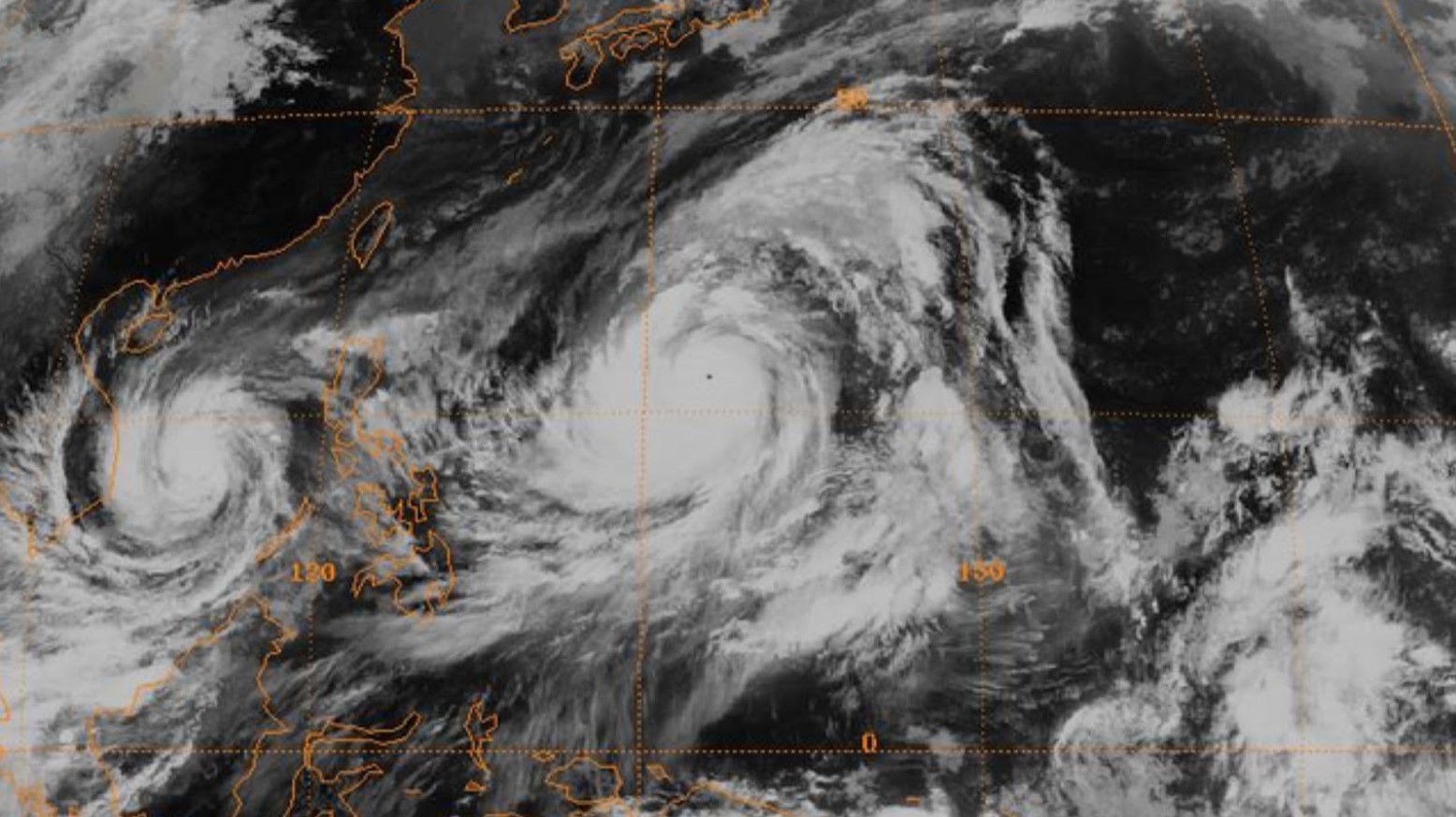 A satellite image of Typhoon Tip. The cloud is spinning in different areas and there are orange lines from the satellite over the typhoon image showing where the area is.