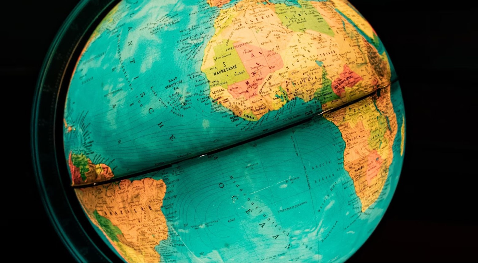 A lit-up globe, with Africa and South America showing in the picture.