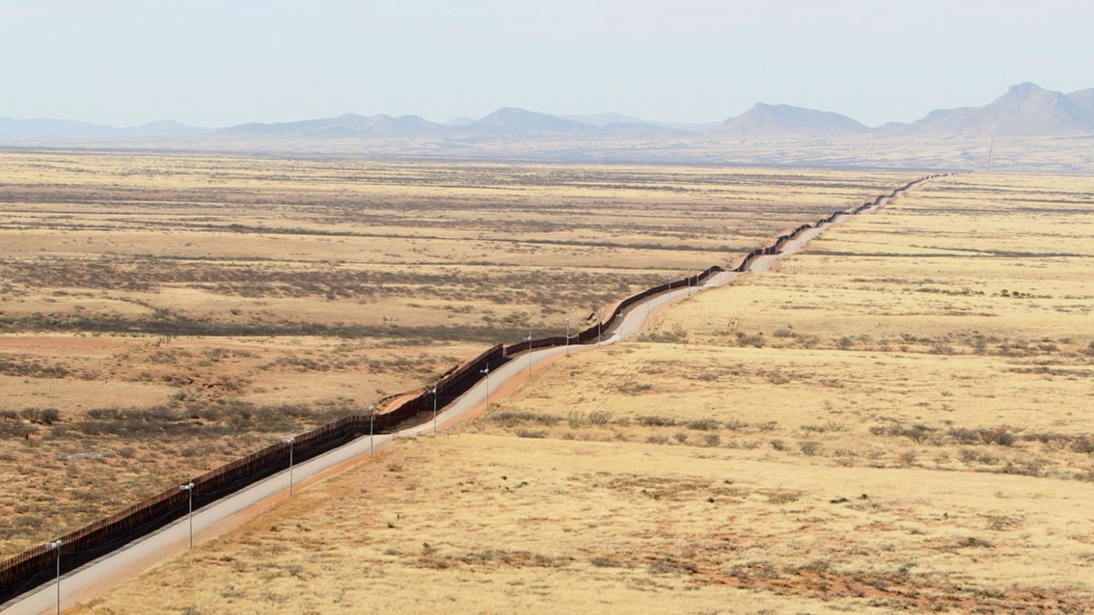 An aerial view of the U.S.-Mexico border in Arizona seen in the daytime.