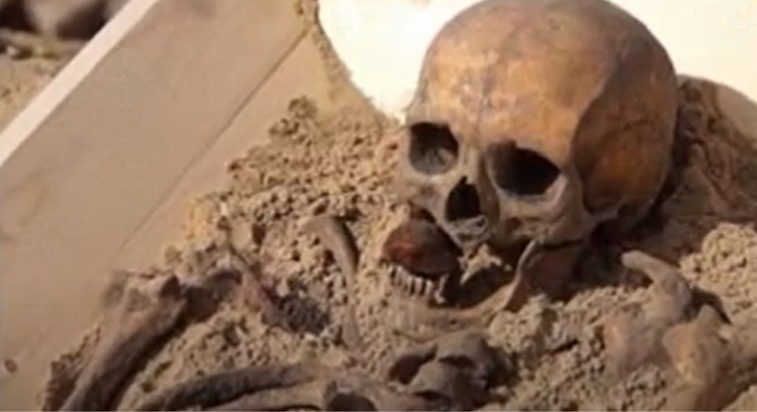 A medieval skeleton with a stone in the mouth.